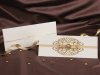      Esküvői meghívó - 240x100 mm - felfelé nyitható - krémszínű papír, elején arany csillámos díszítéssel, barna szaténszalaggal, gyönggyel - betétlapos