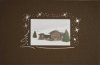 Karácsonyi üdvözlőlap - 150x100 mm - felfelé hajtható - borító: sötétbarna karton, ablakkivágással, ezüst fóliadíszítéssel - betétlap: színes képpel